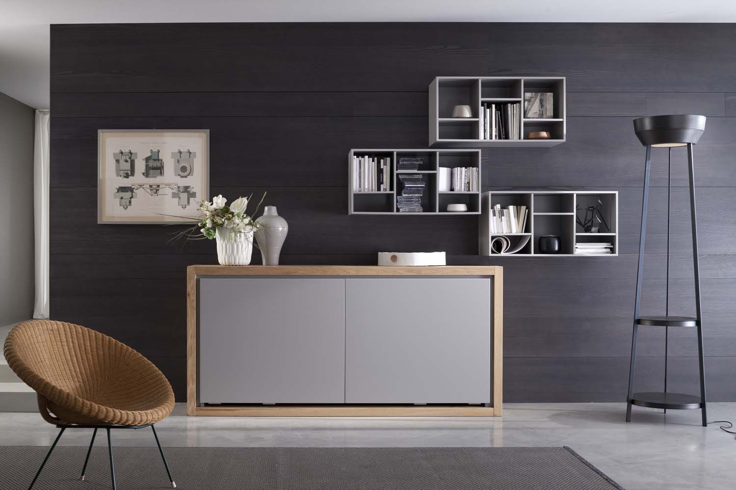 Pared de un salón con estanterías, un mueble y una lámpara de estilo moderno en tonos grises y marfil